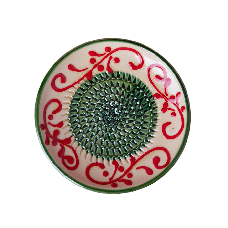 Decorative plate with red floral patterns on a pink background