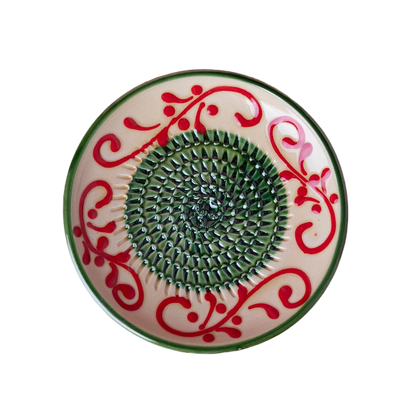 Decorative plate with red floral patterns on a pink background