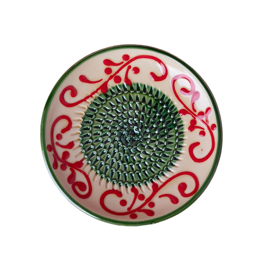 Decorative plate with red floral patterns on a pink background