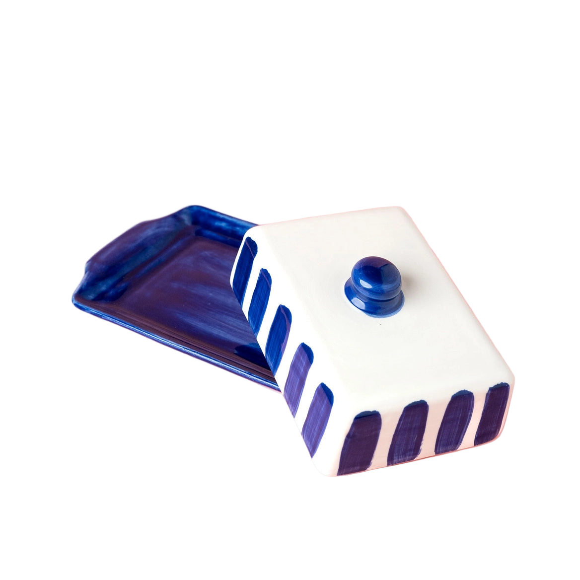 Ceramic container with blue and white design on a pink background