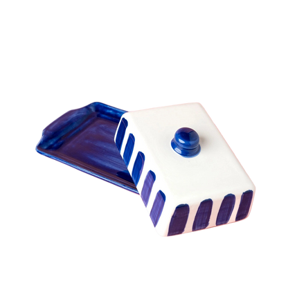 Ceramic container with blue and white design on a pink background